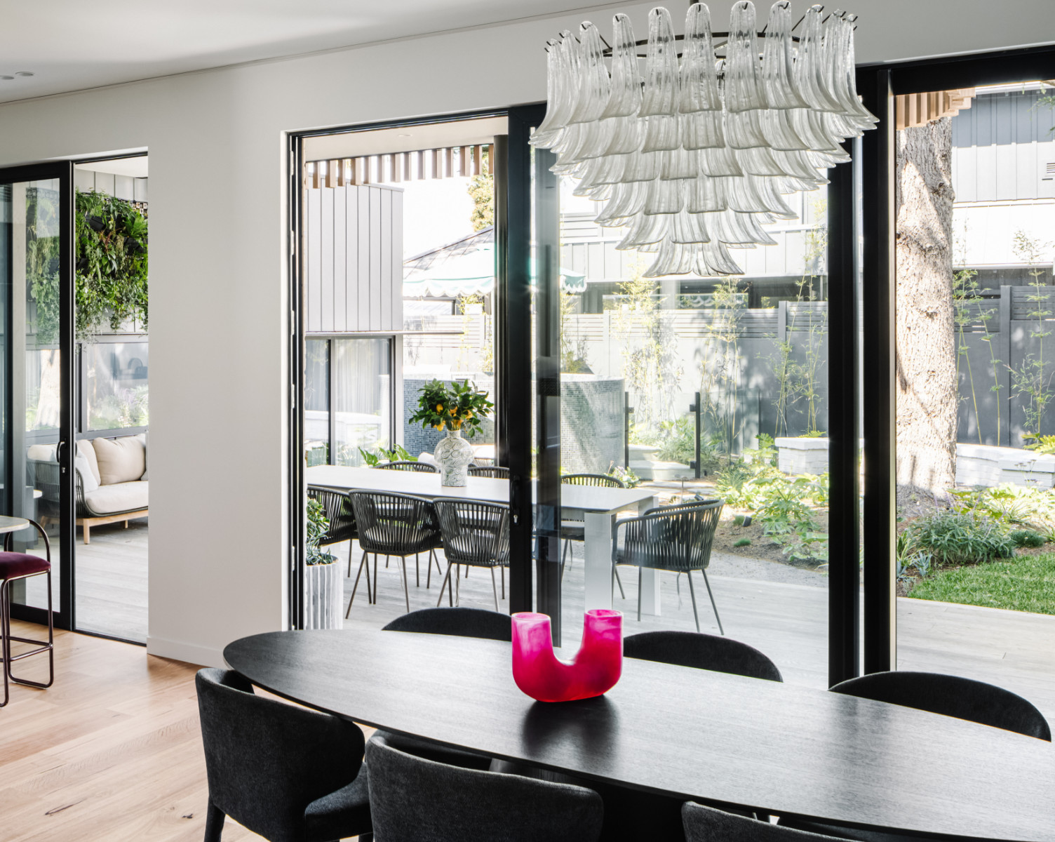 Modern interior with PVC windows offering high thermal and acoustic insulation, connecting the dining room to the garden